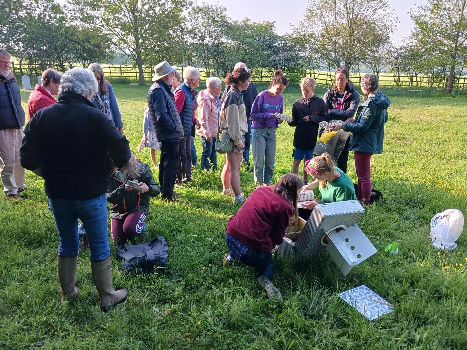 The Diocesan team and parishioners gathered around the moth trap in the meadow at dawn for the Moth Breakfast