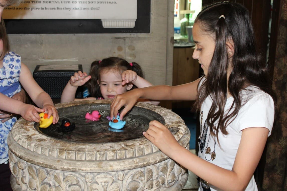 Children gathered at the font
