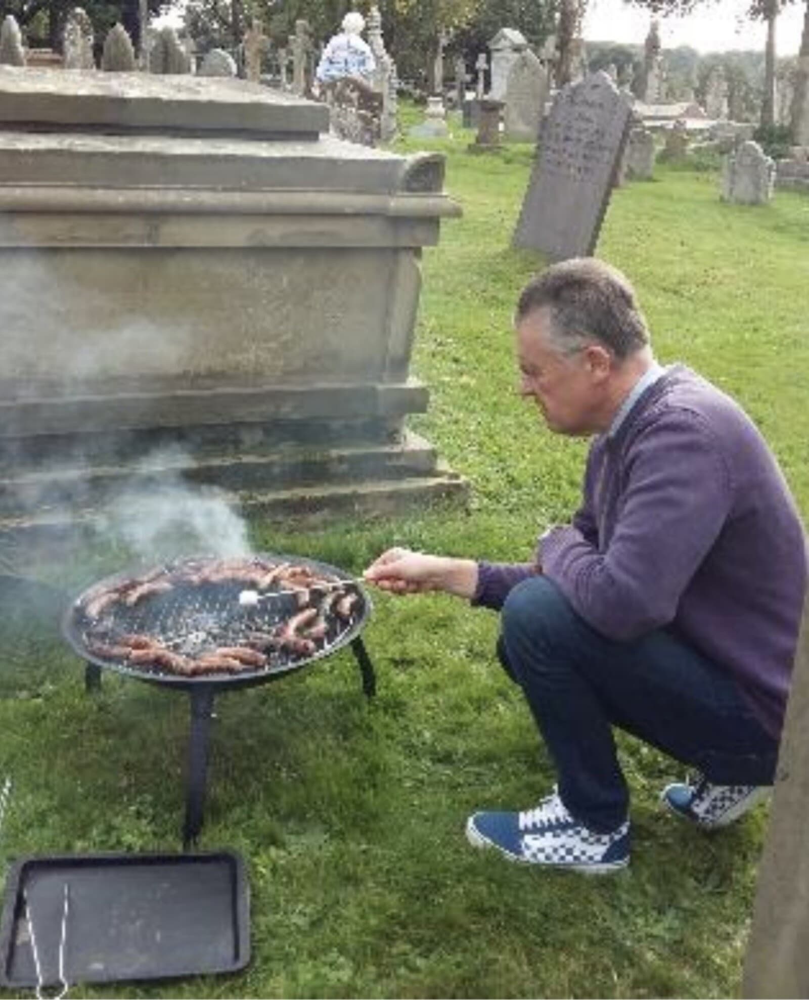 Hot dogs cooking on a fire pit in the churchyard during a Muddy Church afternoon