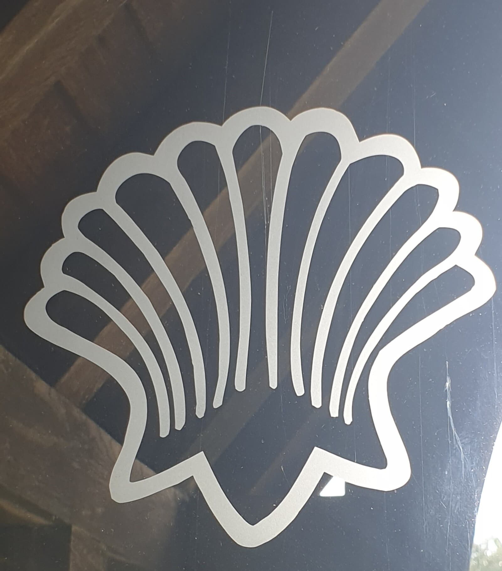 The scallop shell of St James, cut into the glazed screen inside the church