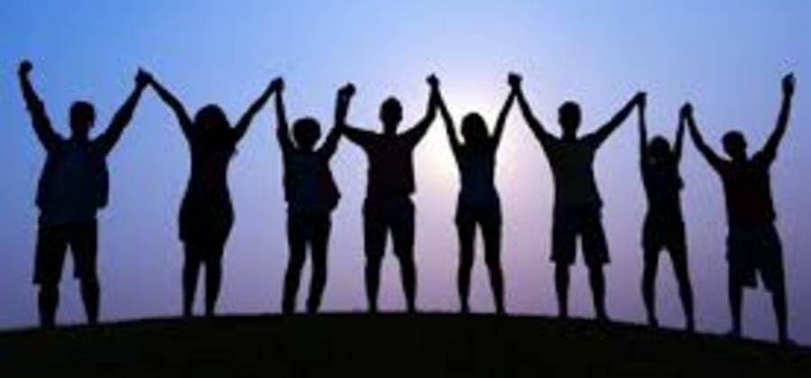 Young people silhouetted against the evening sky